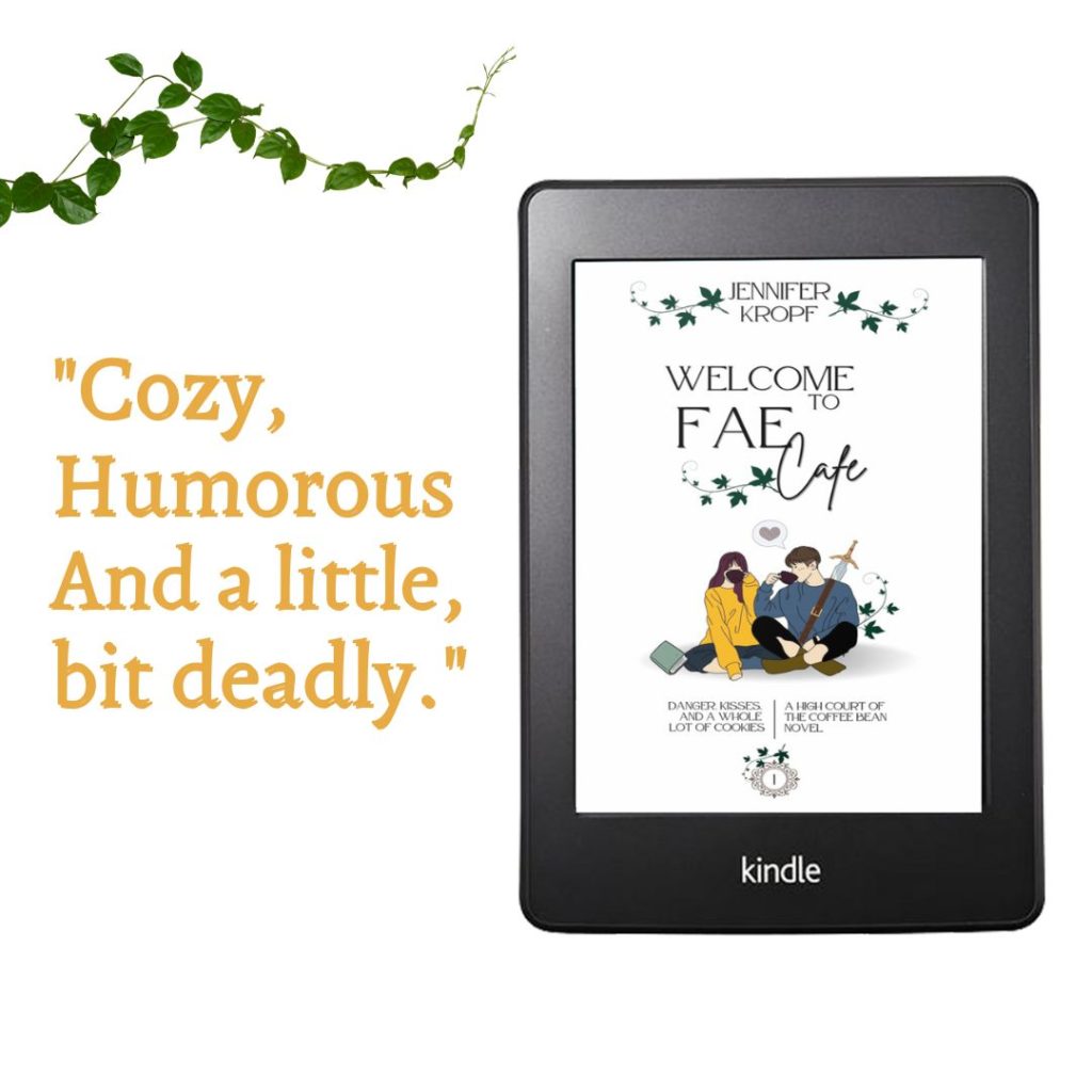 Welcome to the Fae Cafe book on a Kindle reader with words Cozy Humorous and a little bit deadly.