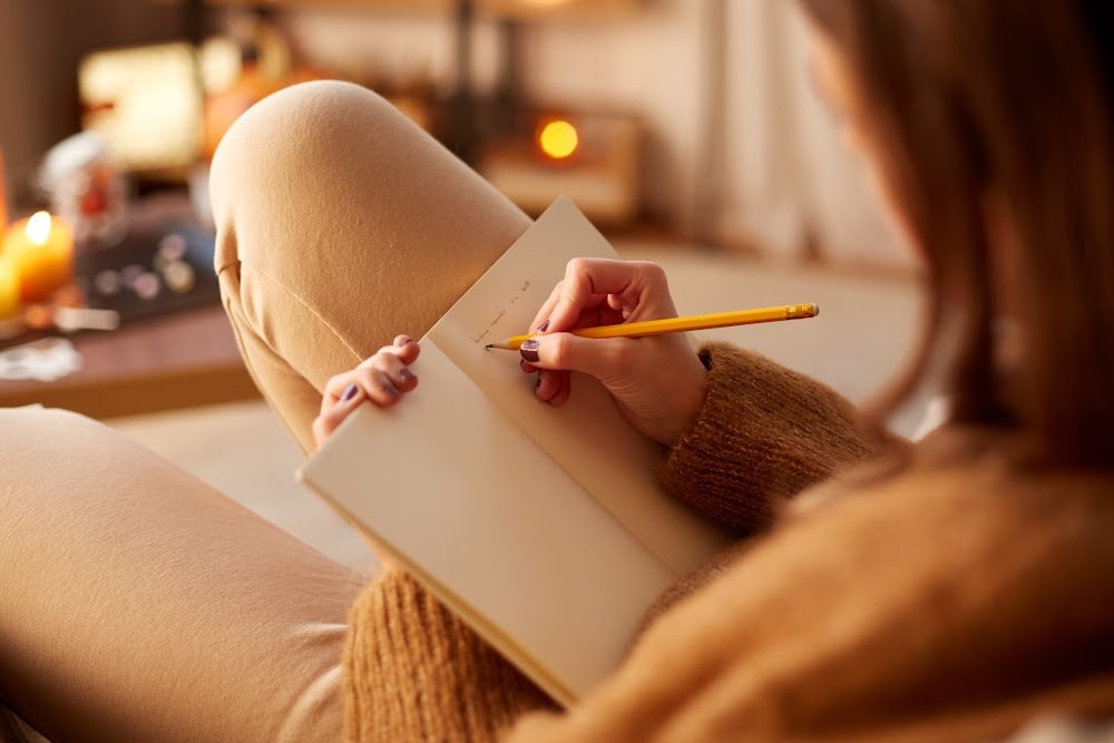 woman writing in a notebook