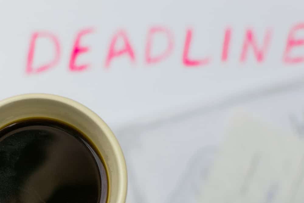 deadline written on a piece of paper and coffee