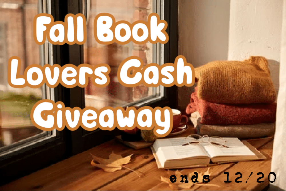 table with sweaters coffee a book and autumn leaves in front of a window