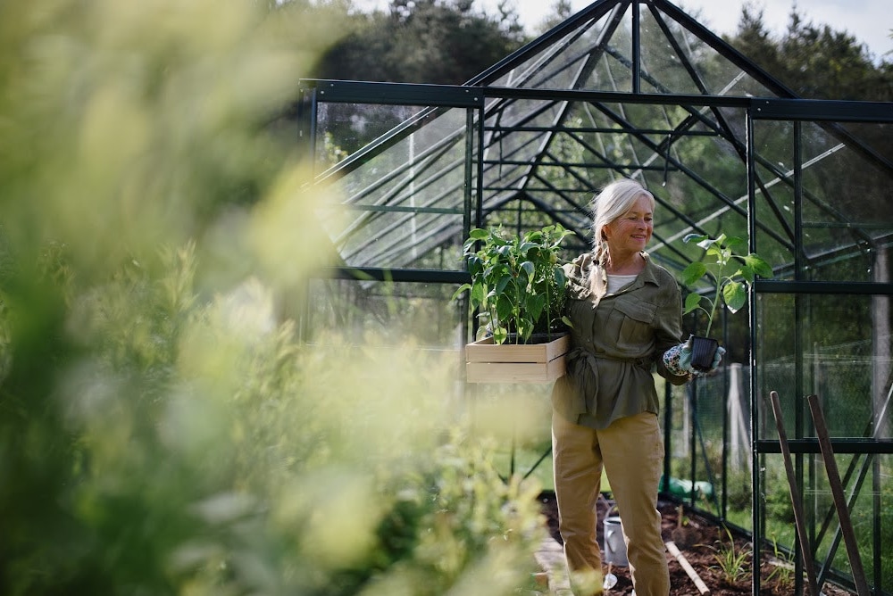 woman in a green house with plants