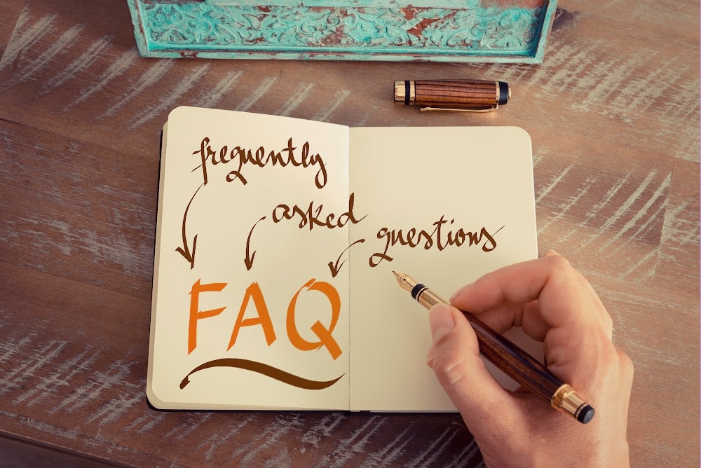 a writer writing in a notebook FAQ frequently asked questions
