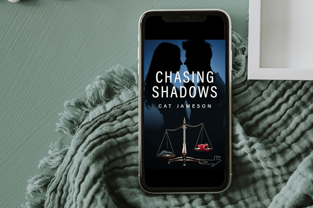 Chasing Shadows by Cat Jameson on a phone laying on a blanket