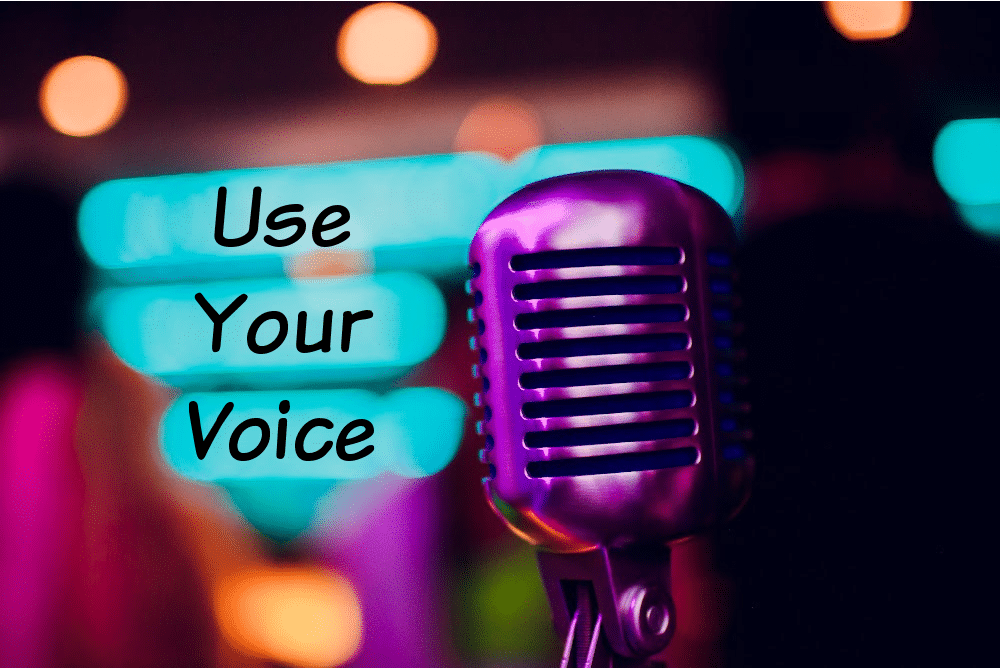 purple microphone at a spoken word poetry slam and the words use your voice