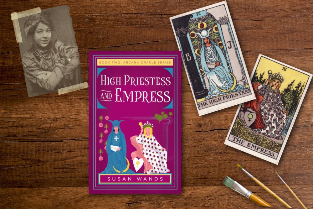 a phot of Pamela Colman Smith the high priestess and empress tarot cards, paint brushes and the book Hihg Priestess and Empress by Susan Wands