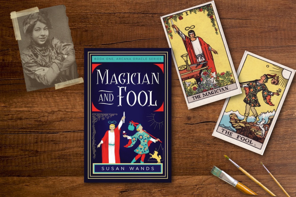 A phot of Pamela Colman Smith the Magician tarot card, the fool tarot card paint brushes and the book Magician and the Fool by Susan Wands